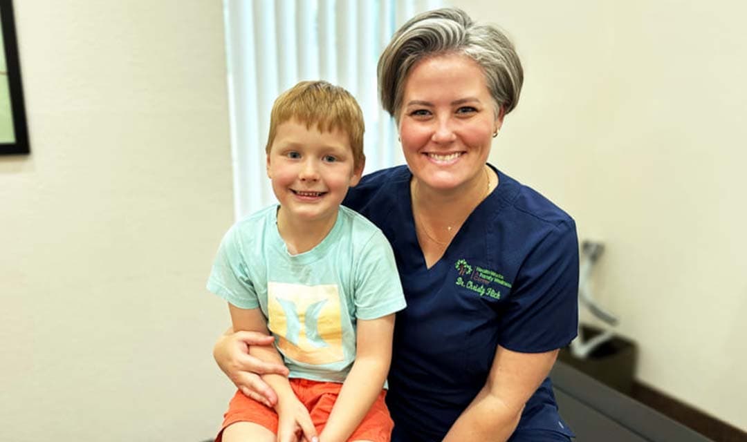 Dr Christy Flick and young patient smiling at the camera